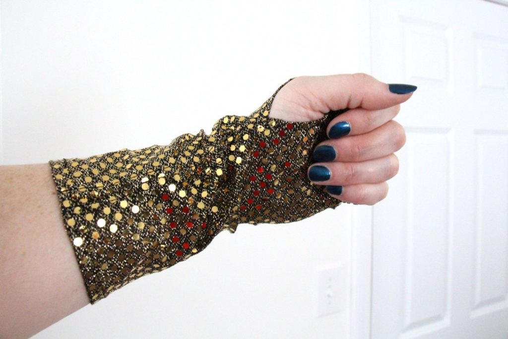 The palm of my black and gold sequined fingerless glove.