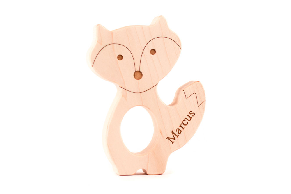 The front of a personalized wooden fox teether from Smiling Tree Toys.