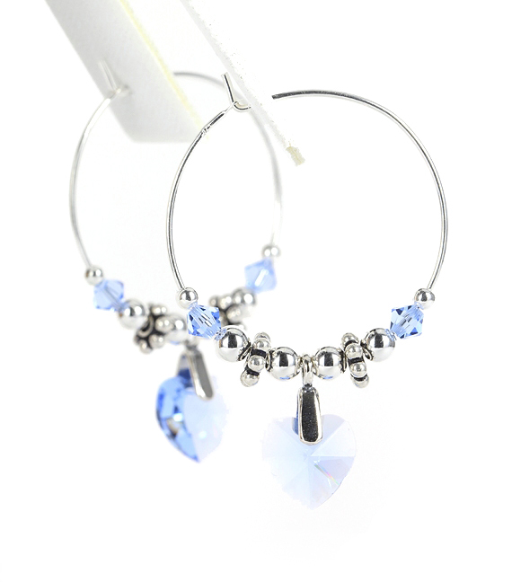 Light sapphire crystal heart earrings on medium sterling silver hoops.